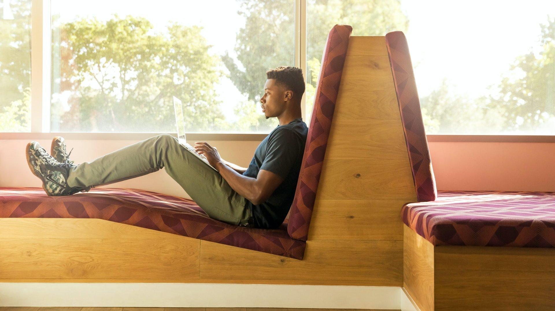 man working in cozy sofa